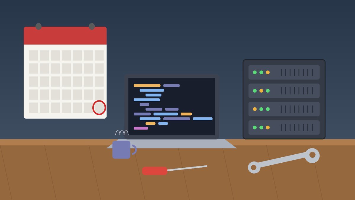 A laptop and a small server on a workbench beside a wall calendar with one day circled in red, a spanner and screwdriver laid out ready for maintenance